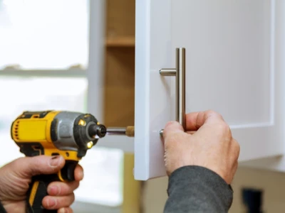 Man attaching cupboard door handle