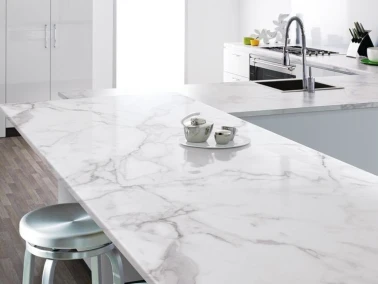 A modern kitchen with a white and grey marble-effect island countertop.