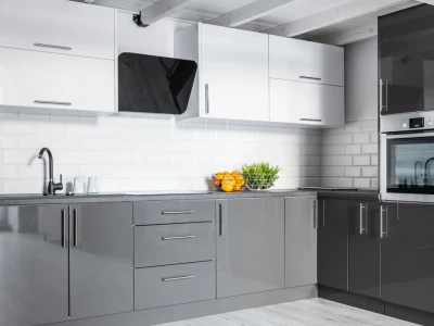 A modern two-tone kitchen with high-gloss grey base cabinets, white upper cabinets, and a white tile backsplash.